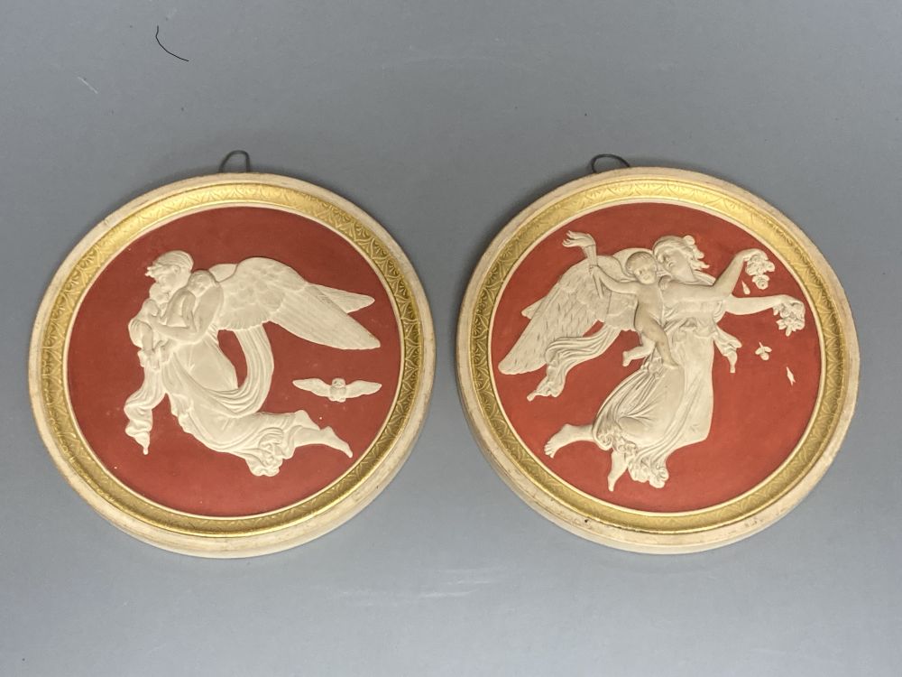 A pair of P. Ipsen Kjobenhavn Eneret relief moulded roundels, depicting night and day, 13cm